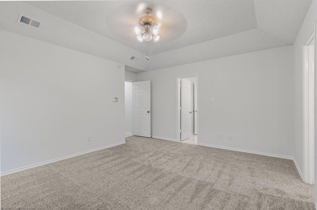 2810 Live Oak Dr, Rowlett, TX 75088 - empty room featuring ceiling fan, light carpet, baseboards, and a tray ceiling