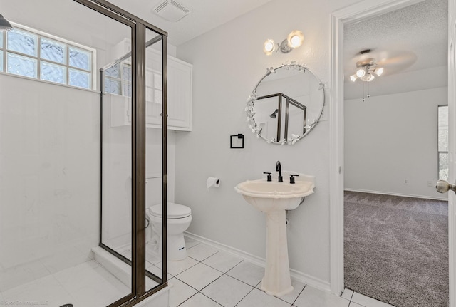 2810 Live Oak Dr, Rowlett, TX 75088 - full bath with a shower stall, toilet, baseboards, ceiling fan, and tile patterned floors