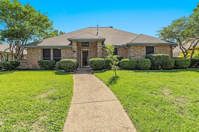 2810 Live Oak Dr, Rowlett, TX 75088 - view of front of home featuring brick siding, a front lawn, and a shingled roof