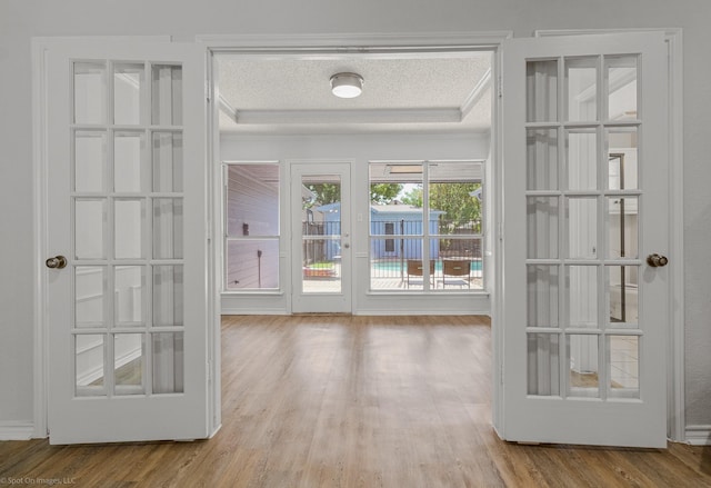 2810 Live Oak Dr, Rowlett, TX 75088 - doorway to outside with a tray ceiling and wood finished floors