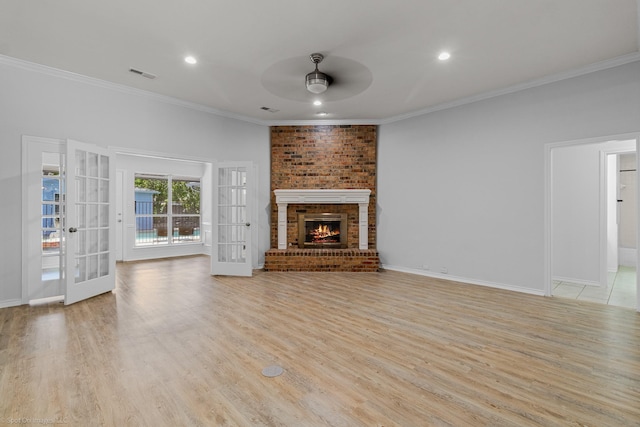 2810 Live Oak Dr, Rowlett, TX 75088 - unfurnished living room with ceiling fan, crown molding, light wood-type flooring, french doors, and a brick fireplace