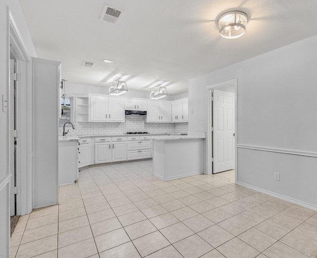 2810 Live Oak Dr, Rowlett, TX 75088 - kitchen featuring under cabinet range hood, light countertops, gas stovetop, and open shelves