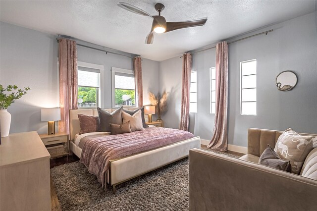 738 N Edgefield Ave, Dallas, TX 75208 - bedroom featuring wood finished floors, a textured ceiling, baseboards, and ceiling fan