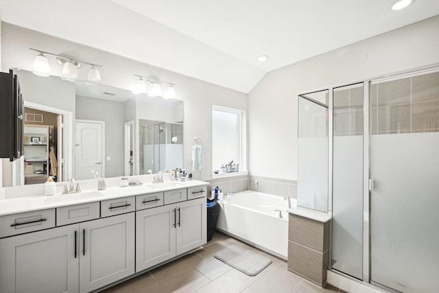 3613 Texas Dall Ct, Mckinney, TX 75071 - bathroom featuring a shower stall, double vanity, a garden tub, lofted ceiling, and recessed lighting