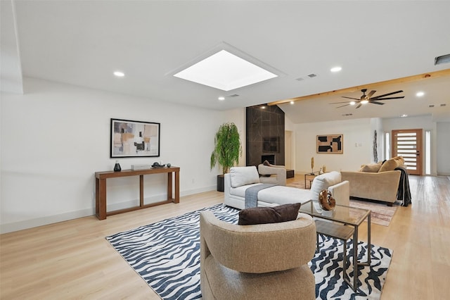 1425 Cassandra Cir, Desoto, TX 75115 - living area with a skylight, light wood-style floors, vaulted ceiling, baseboards, and recessed lighting