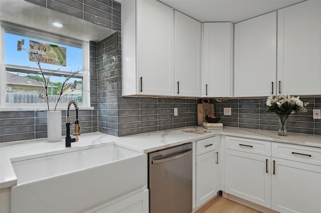 1425 Cassandra Cir, Desoto, TX 75115 - kitchen with stainless steel dishwasher, a sink, decorative backsplash, white cabinets, and light stone countertops