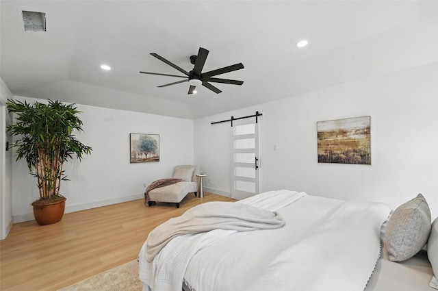 1425 Cassandra Cir, Desoto, TX 75115 - bedroom with a barn door, wood finished floors, recessed lighting, baseboards, and ceiling fan