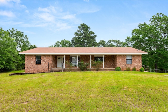 2630 E Lake Dr, Gladewater, TX 75647 - ranch-style house with a front lawn, brick siding, and a porch