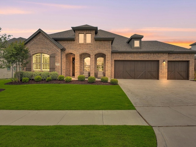 8620 Bandon Dunes Dr, Mckinney, TX 75070 - french country inspired facade with brick siding, a garage, and a shingled roof