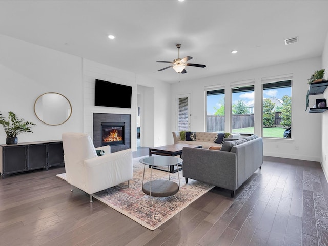 8620 Bandon Dunes Dr, Mckinney, TX 75070 - living room featuring a tiled fireplace, wood finished floors, baseboards, recessed lighting, and a ceiling fan