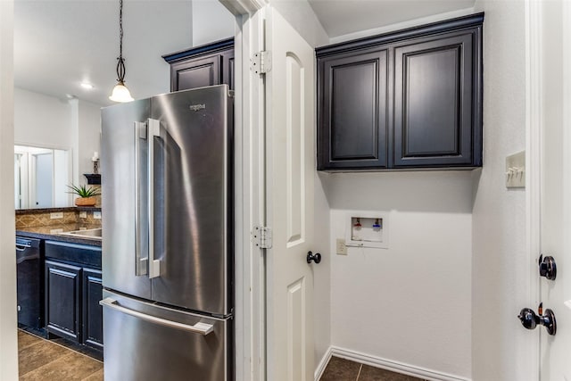 405 Lockwood Ln, Weatherford, TX 76087 - kitchen with freestanding refrigerator, dark tile patterned flooring, black dishwasher, hanging light fixtures, and dark countertops