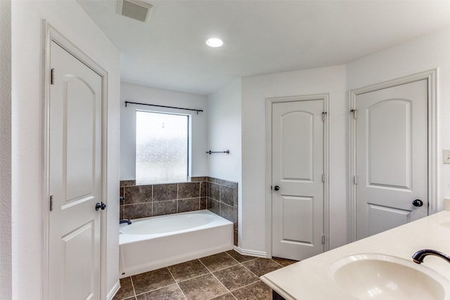 405 Lockwood Ln, Weatherford, TX 76087 - bathroom with a bath, tile patterned floors, double vanity, recessed lighting, and baseboards