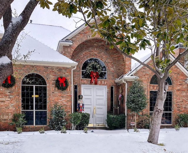 7100 Deer Run, Plano, TX 75024 - snow covered property entrance with brick siding