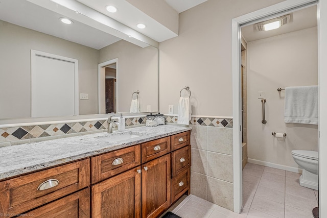 2012 Island Cir, Tool, TX 75143 - full bathroom featuring vanity, toilet, tile patterned floors, recessed lighting, and tile walls