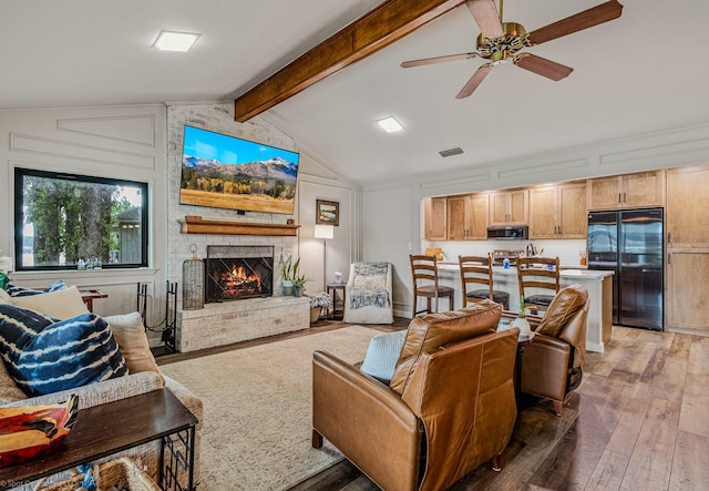 2012 Island Cir, Tool, TX 75143 - living room featuring wood-type flooring, a brick fireplace, and a ceiling fan