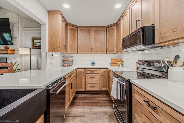 2012 Island Cir, Tool, TX 75143 - kitchen with stainless steel electric range, black microwave, dark wood finished floors, tasteful backsplash, and recessed lighting