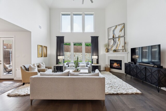 14326 Sedgegrass Dr, Frisco, TX 75033 - living area featuring a high ceiling, a glass covered fireplace, and dark wood-style flooring
