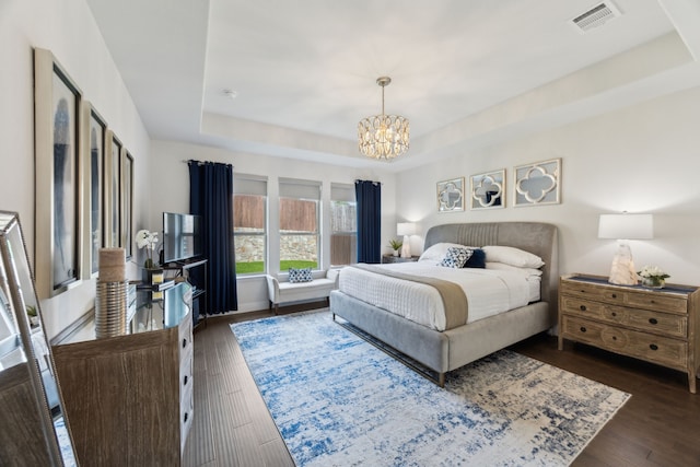 14326 Sedgegrass Dr, Frisco, TX 75033 - bedroom featuring a tray ceiling, a chandelier, and dark wood finished floors