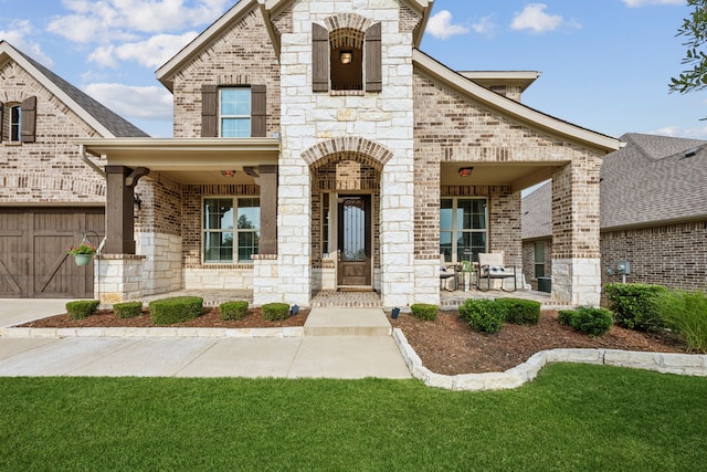 14326 Sedgegrass Dr, Frisco, TX 75033 - french provincial home featuring covered porch, brick siding, stone siding, and a garage