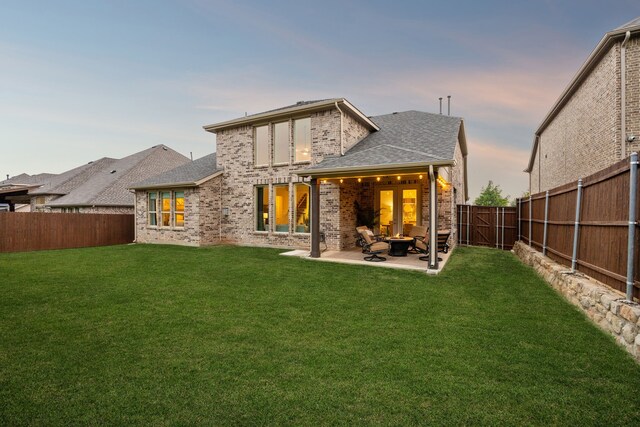 14326 Sedgegrass Dr, Frisco, TX 75033 - back of property at dusk with a patio area, a shingled roof, and brick siding