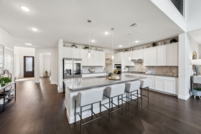 14326 Sedgegrass Dr, Frisco, TX 75033 - kitchen featuring a sink, appliances with stainless steel finishes, decorative backsplash, a breakfast bar area, and recessed lighting