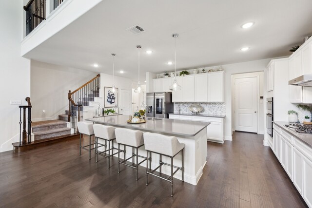 14326 Sedgegrass Dr, Frisco, TX 75033 - kitchen with stainless steel appliances, recessed lighting, backsplash, dark wood-type flooring, and a kitchen bar