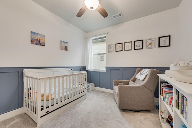 3044 Wind Knot Way, Royse City, TX 75189 - carpeted bedroom featuring a wainscoted wall, a ceiling fan, and a nursery area