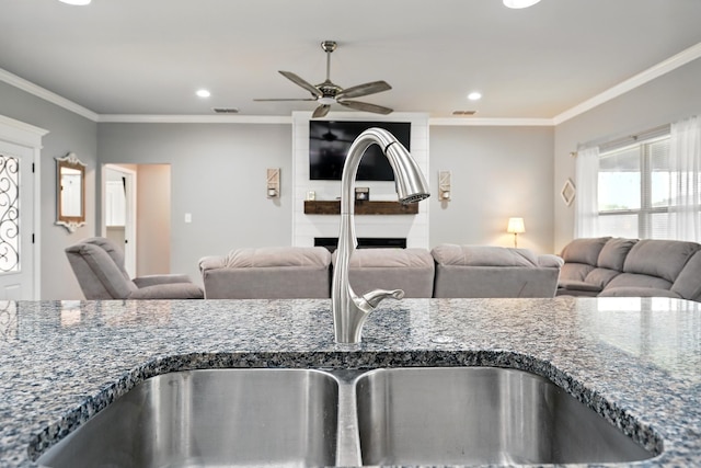 925 8th St, Tuscola, TX 79562 - kitchen view of a sink, crown molding, ceiling fan, and recessed lighting