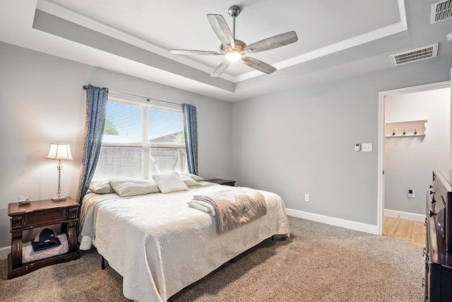 925 8th St, Tuscola, TX 79562 - carpeted bedroom featuring a tray ceiling, ornamental molding, baseboards, and ceiling fan