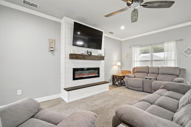 925 8th St, Tuscola, TX 79562 - living area with wood finished floors, crown molding, ceiling fan, baseboards, and a fireplace