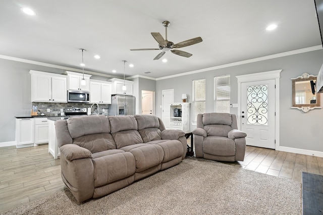 925 8th St, Tuscola, TX 79562 - living area with light wood finished floors, a ceiling fan, ornamental molding, baseboards, and recessed lighting