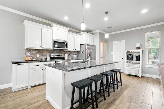 925 8th St, Tuscola, TX 79562 - kitchen with stainless steel appliances, a sink, ornamental molding, decorative backsplash, and baseboards