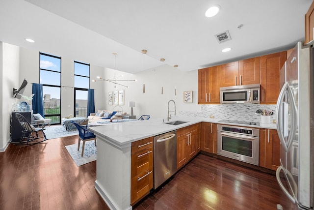2608 Museum Way Unit 3417, Fort Worth, TX 76107 - kitchen with appliances with stainless steel finishes, a sink, brown cabinetry, open floor plan, and recessed lighting