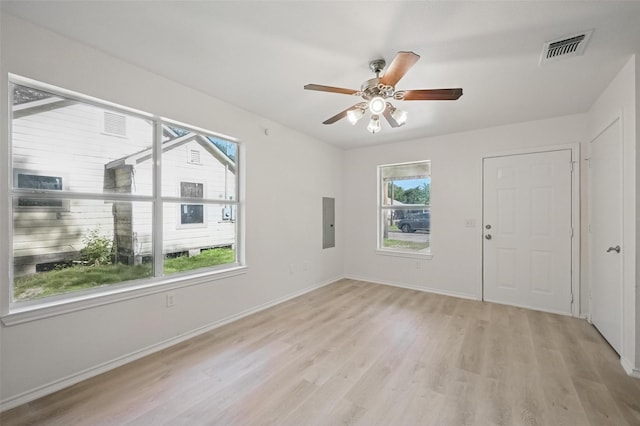 714 E 12th St, Bonham, TX 75418 - spare room with light wood-style floors, a ceiling fan, electric panel, and baseboards