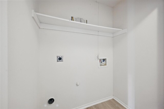 714 E 12th St, Bonham, TX 75418 - laundry area featuring washer hookup, hookup for a gas dryer, light wood finished floors, and baseboards