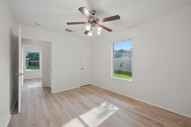 714 E 12th St, Bonham, TX 75418 - unfurnished bedroom featuring light wood finished floors, baseboards, and a ceiling fan