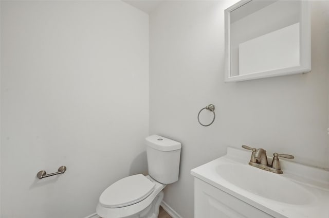 714 E 12th St, Bonham, TX 75418 - half bath featuring toilet, vanity, and baseboards