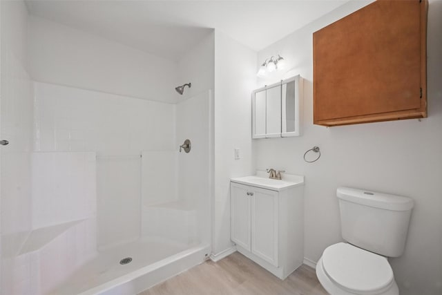 714 E 12th St, Bonham, TX 75418 - full bathroom with vanity, wood finished floors, toilet, a shower, and baseboards