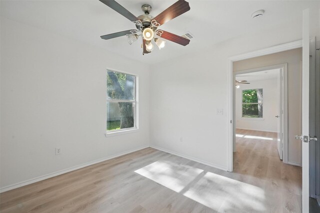 714 E 12th St, Bonham, TX 75418 - spare room with ceiling fan, plenty of natural light, light wood-style floors, and a smoke detector