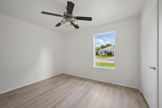 714 E 12th St, Bonham, TX 75418 - spare room featuring light wood finished floors, baseboards, and ceiling fan
