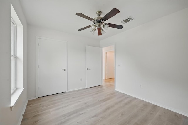 714 E 12th St, Bonham, TX 75418 - unfurnished bedroom featuring light wood-style flooring, baseboards, and multiple windows
