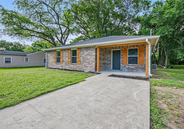 714 E 12th St, Bonham, TX 75418 - view of front of property featuring a porch, a front yard, cooling unit, and stone siding
