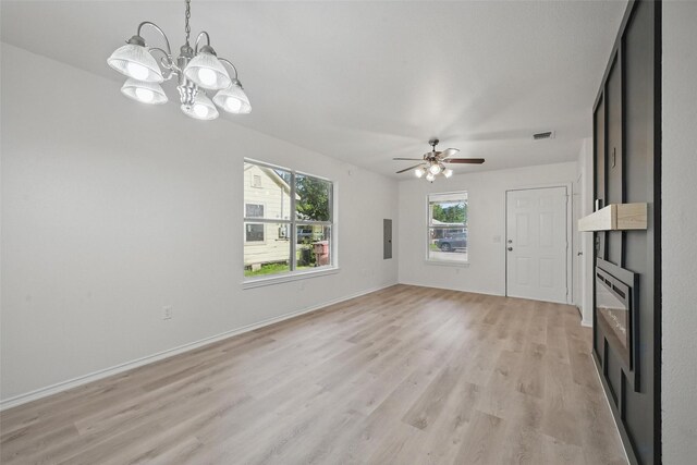 714 E 12th St, Bonham, TX 75418 - unfurnished living room with light wood-style floors, a ceiling fan, baseboards, and a chandelier