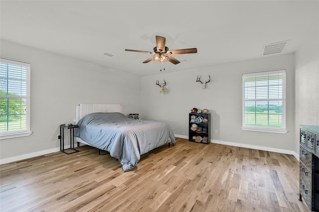 11605 Fm 697, Whitewright, TX 75491 - bedroom with multiple windows, light wood-style flooring, and baseboards