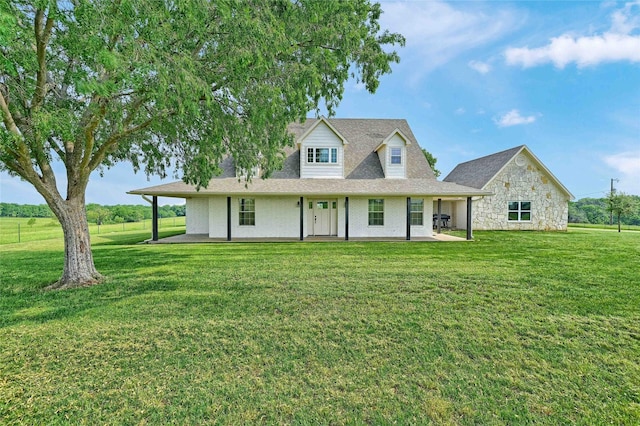 11605 Fm 697, Whitewright, TX 75491 - view of front of home with a front yard, stone siding, a shingled roof, and a patio