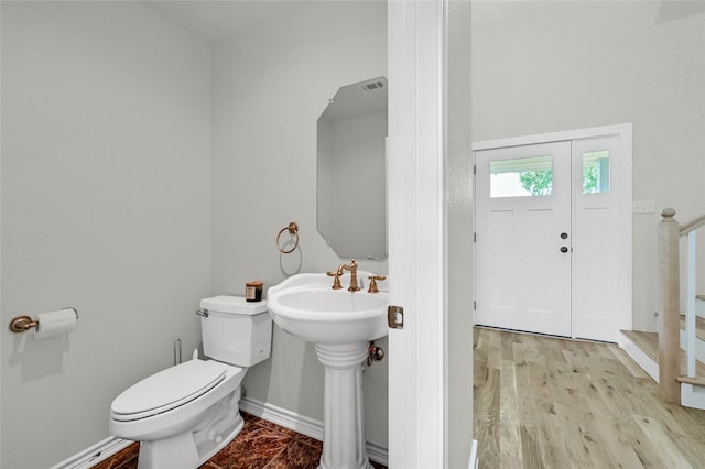 11605 Fm 697, Whitewright, TX 75491 - half bath featuring toilet, baseboards, a sink, and wood finished floors
