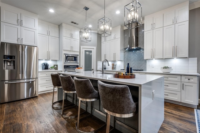 8230 Carter St, Lantana, TX 76226 - kitchen featuring stainless steel appliances, wall chimney exhaust hood, recessed lighting, light countertops, and a center island with sink