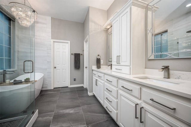 8230 Carter St, Lantana, TX 76226 - bathroom with double vanity, a soaking tub, a chandelier, a shower stall, and baseboards