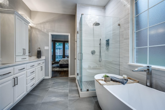 8230 Carter St, Lantana, TX 76226 - ensuite bathroom featuring a stall shower, a freestanding bath, vanity, and marble finish flooring