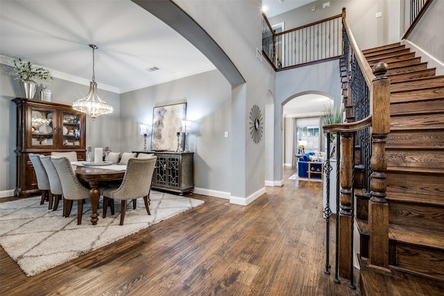 8230 Carter St, Lantana, TX 76226 - dining space featuring arched walkways, wood finished floors, stairs, baseboards, and ornamental molding